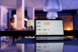 Laptop on a desk showing a Google Ads campaign dashboard with cost-per-lead metrics across multiple local service industry campaigns